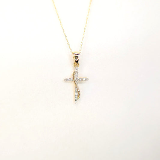 A gold chain displays a delicate diamond cross pendant against a soft white background.
